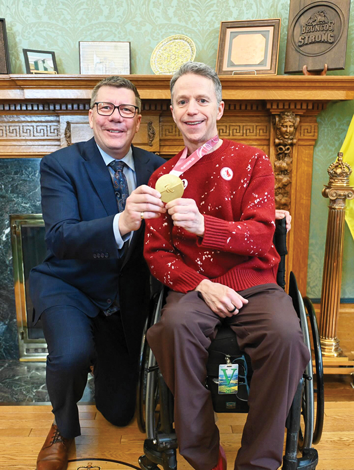 Gil Dash with Premier Scott Moe at the Legislature after winning gold.