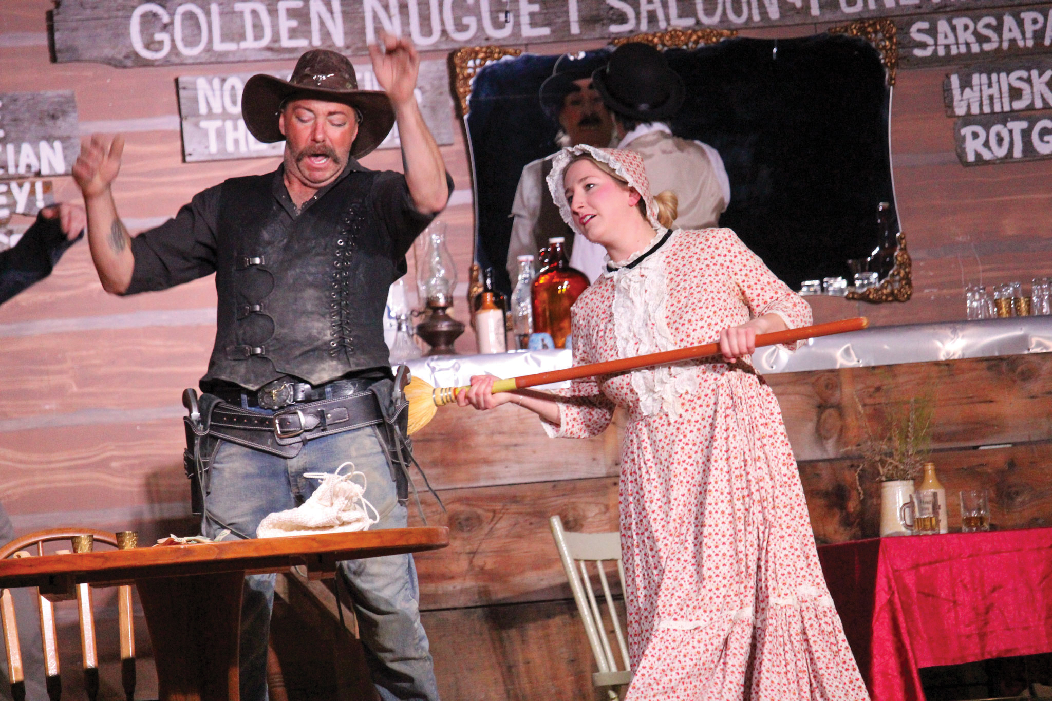 The cast of the Redvers Adult Drama Club performing The Day Black Bart Balderdash and Dangerous Dan McGrew Went to Dueling at Miss Kittys Golden Nugget Saloon.