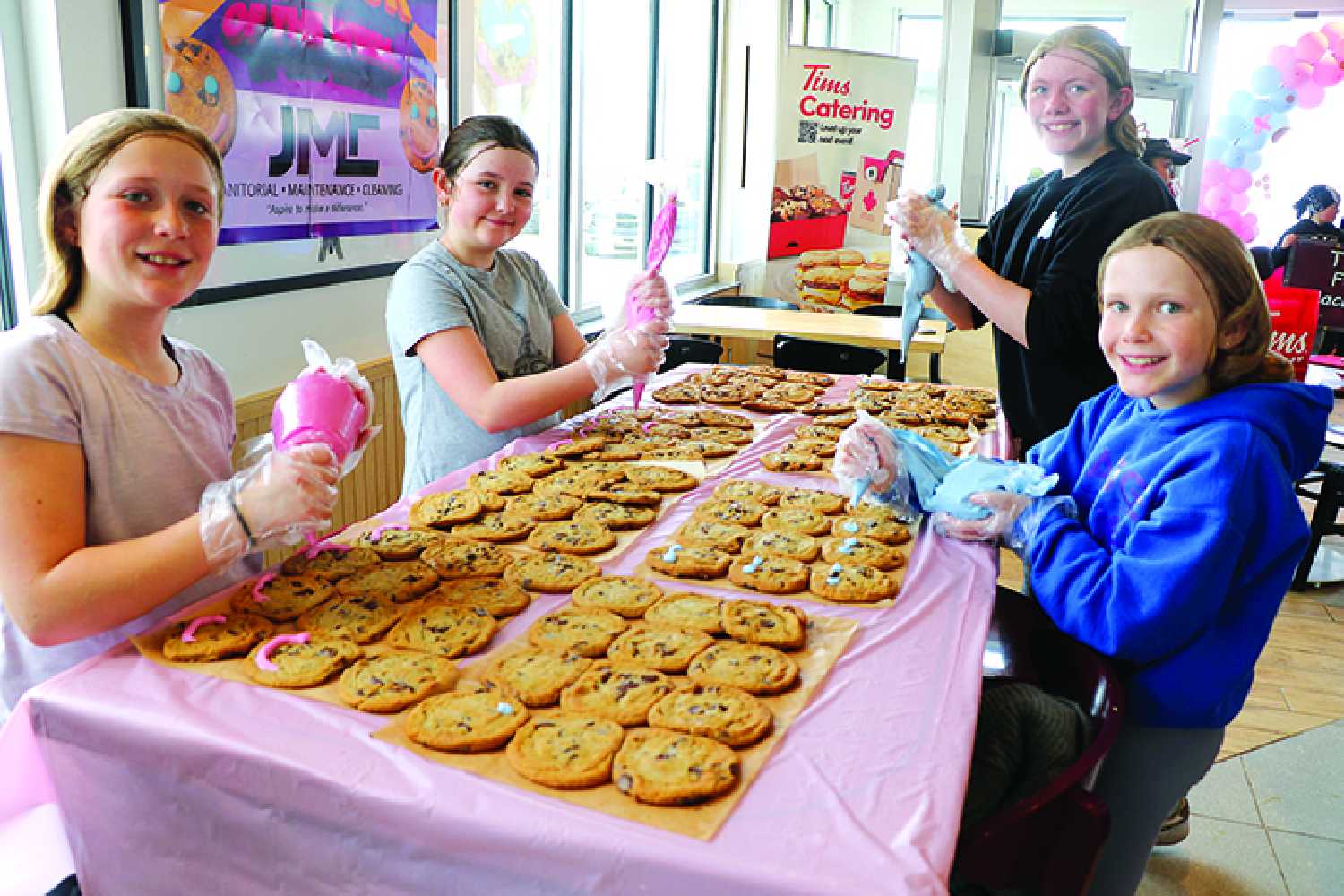 Students volunteering to decorate smile cookies during last year�s Smile Cookie Week